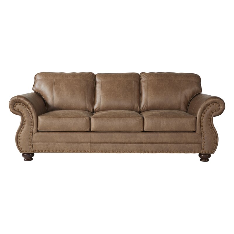A classic sofa with curved round arms and soft cushions