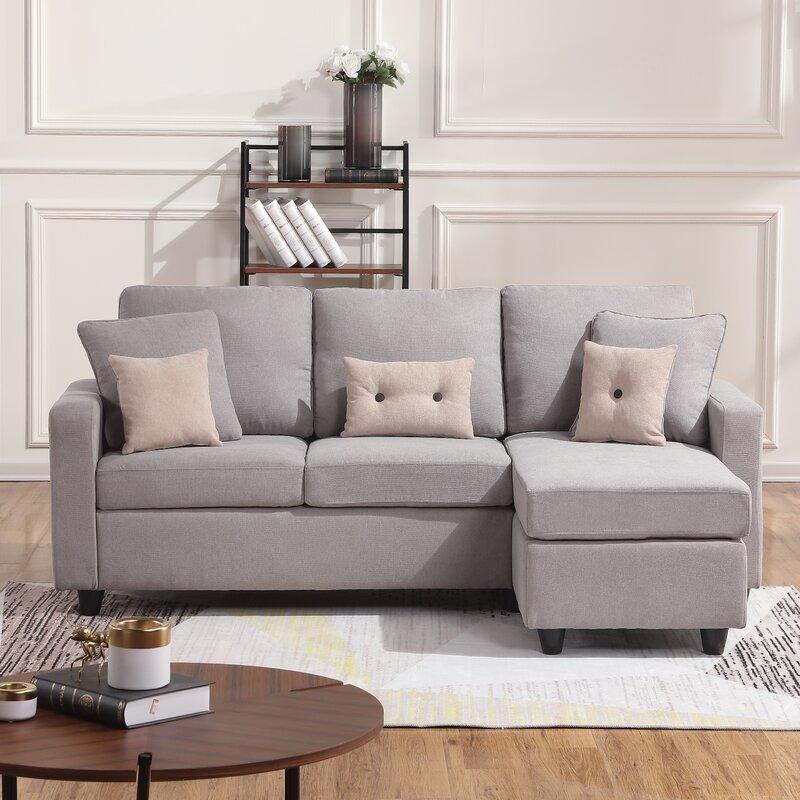 Modern light gray reversible L-shaped sectional sofa in a contemporary living room.