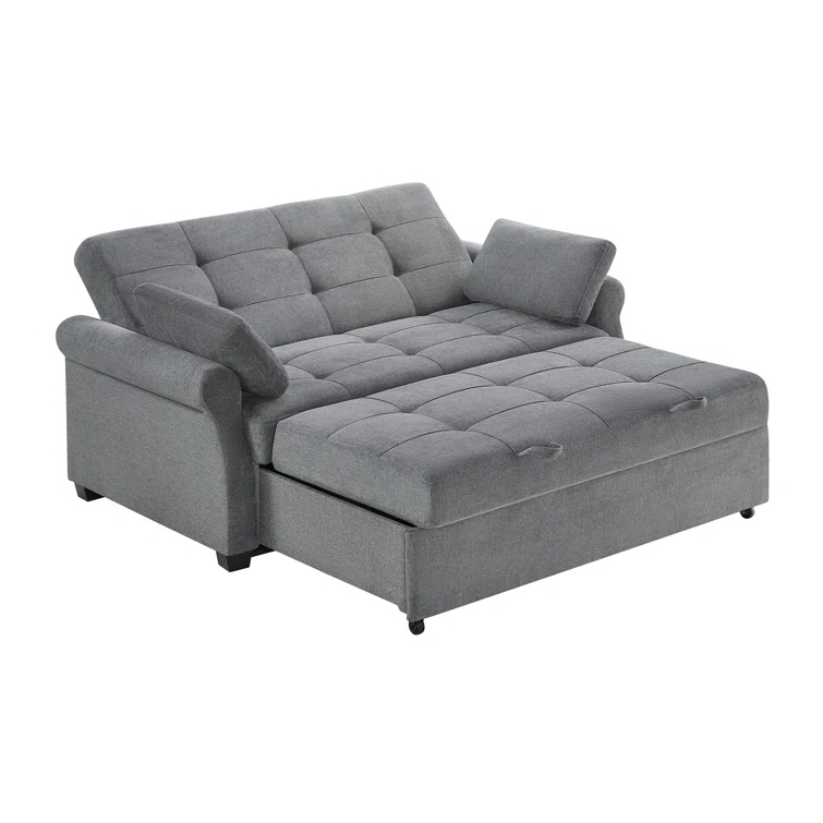 A modern dark gray sleeper sofa with a tufted back and rolled arms.