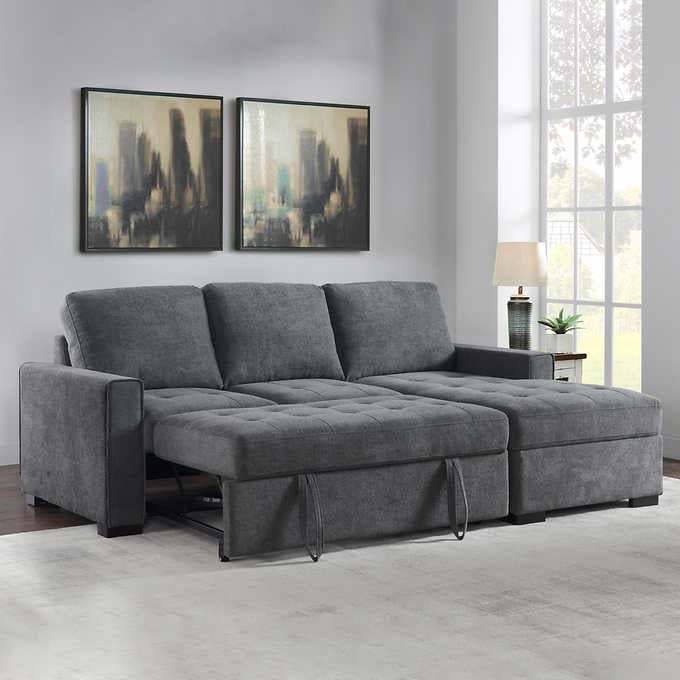 A modern gray sleeper sofa with chaise extended in a contemporary living room