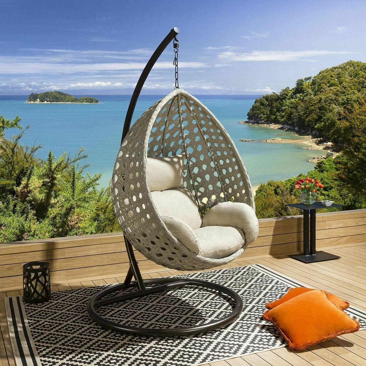 Grey rope hanging pod chair suspended from a stand