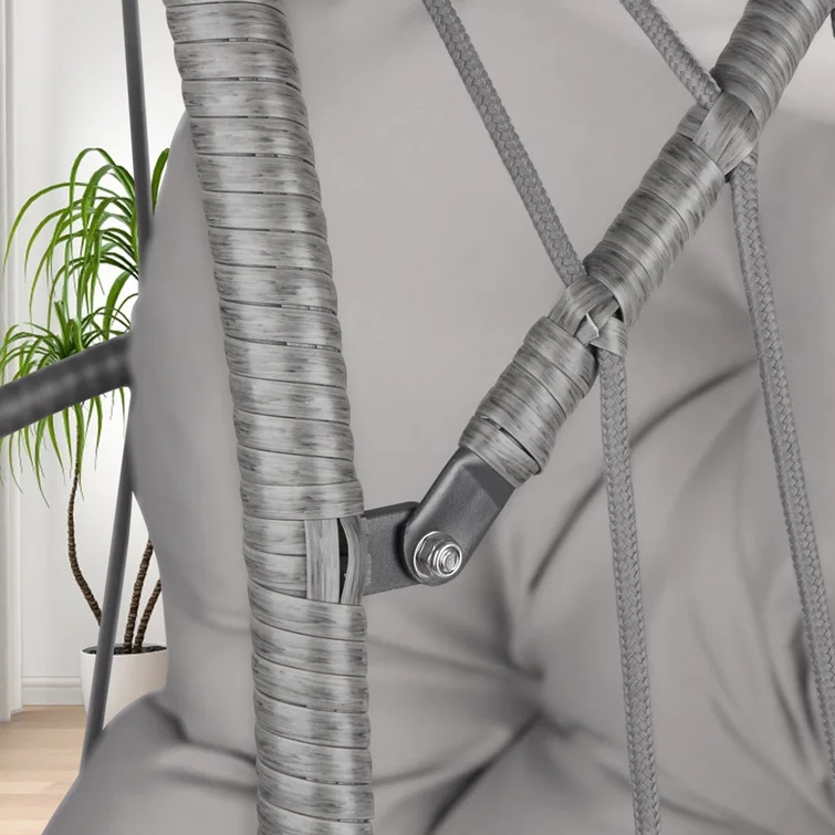 Close-up of a single person relaxing on a gray porch swing.