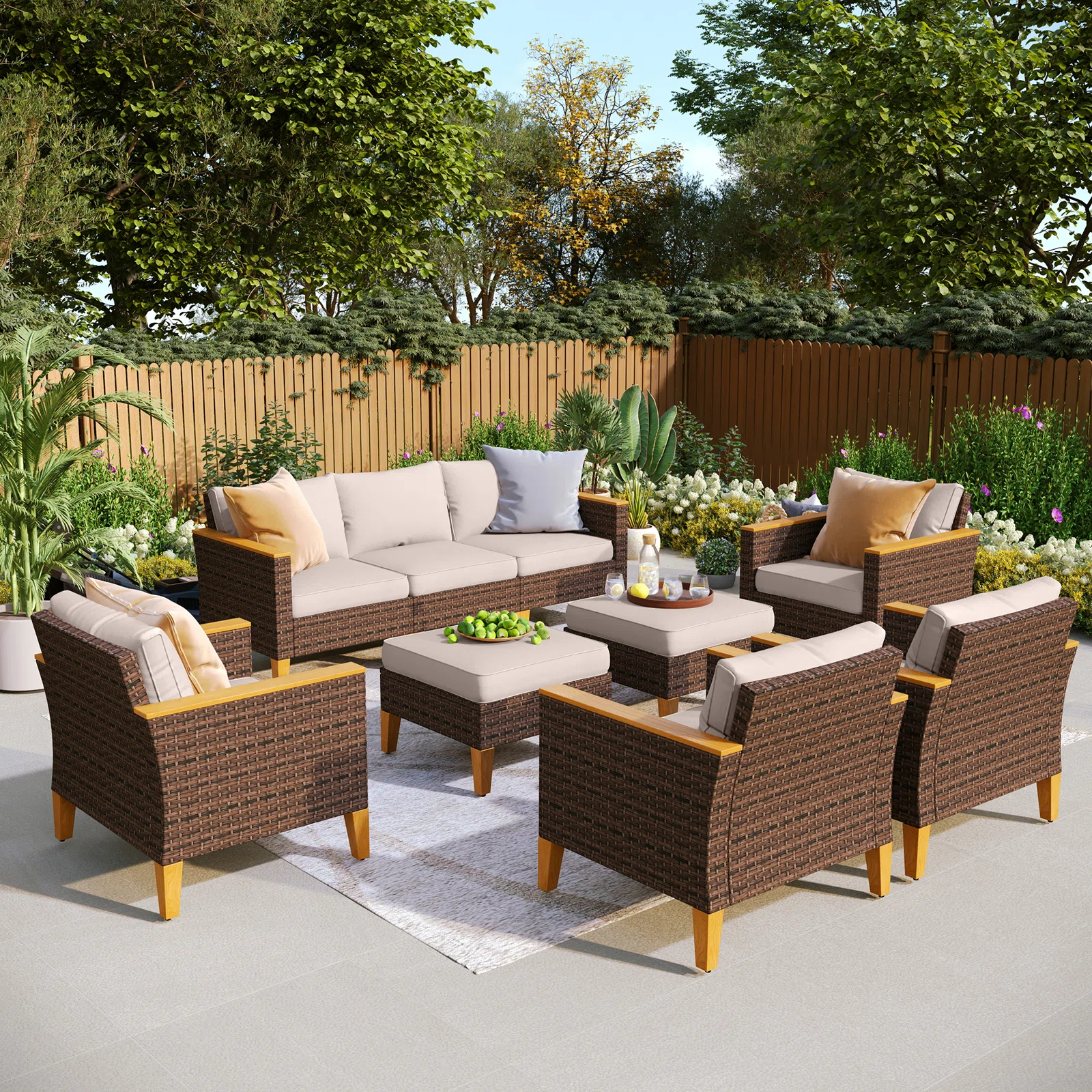 A complete 9-person outdoor wicker sofa set arranged on a stone patio.