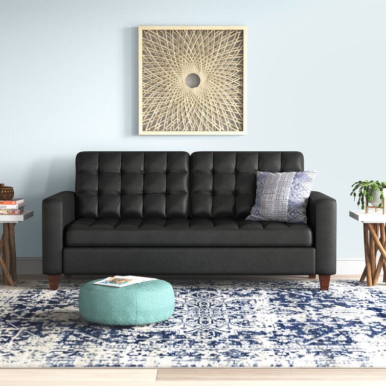 A contemporary sofa with square arms in a vegan leather fabric